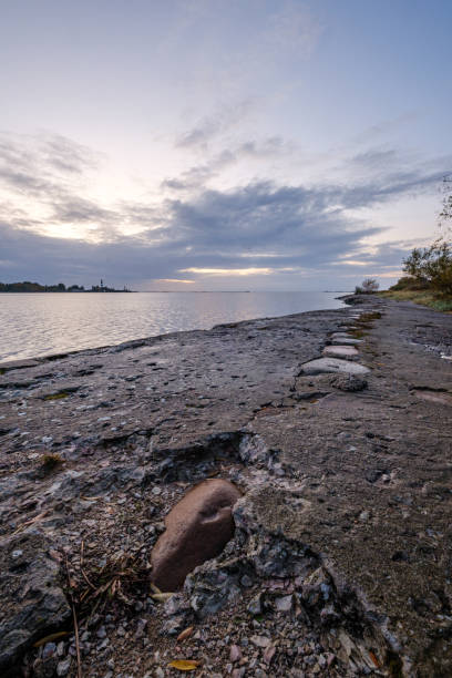 istock frozen sea beach with sand and first snow in cloudy day 1192824252