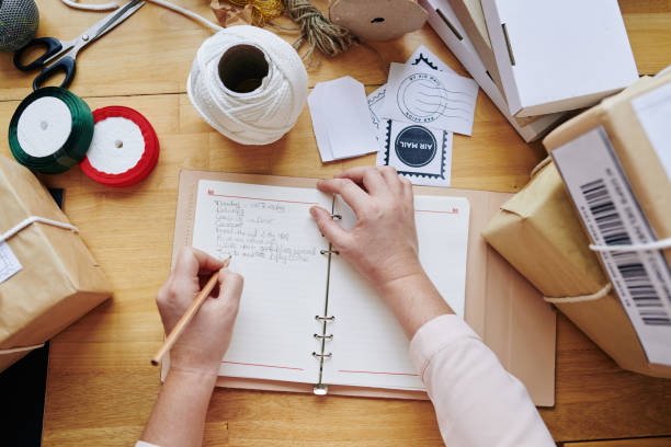 istock Small business owner writing in planner 1192825943