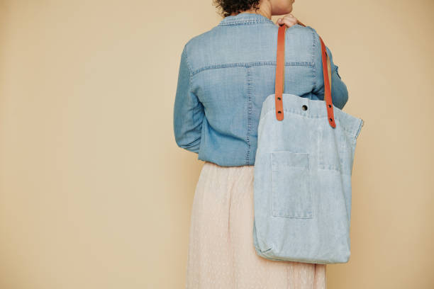 istock Young woman with denim bag 1192826063