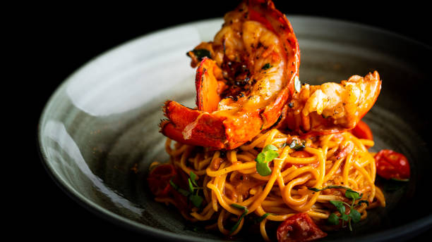 Boiled Lobster with cheese served with Spaghetti