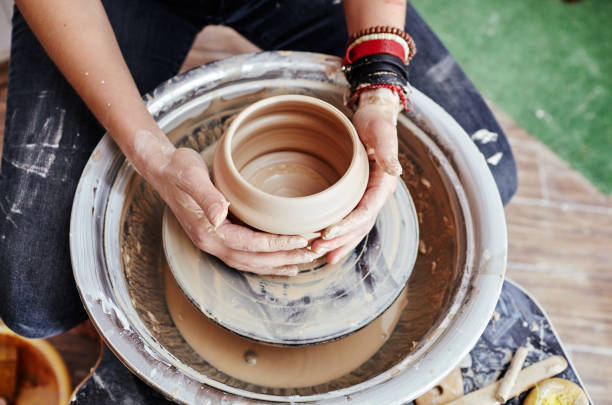 istock Woman's hands molding clay. Potter making ceramic pot in pottery workshop 1192829231