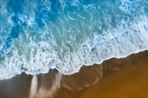 istock Drone aerial view of rough waves on the beach 1192829956