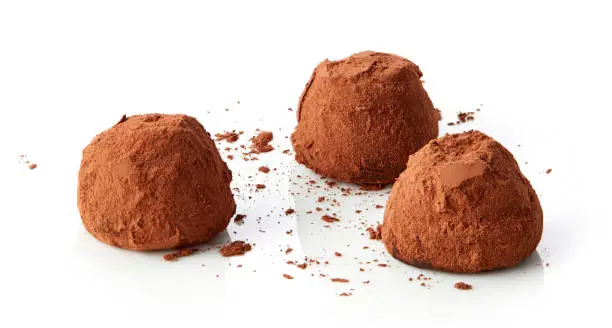 chocolate truffles covered with cocoa isolated on white background