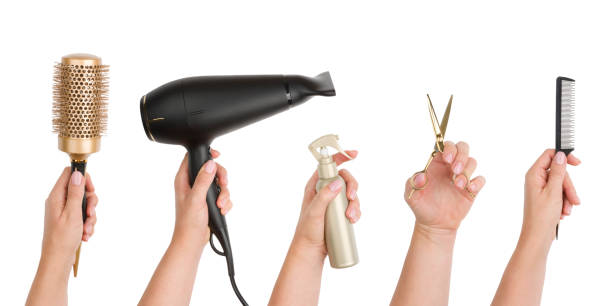 Human hands holding various hairdressing tools isolated on white background