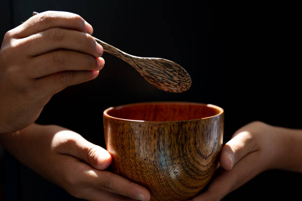 istock hand hold wood soup isolated on black background,front view 1192832438