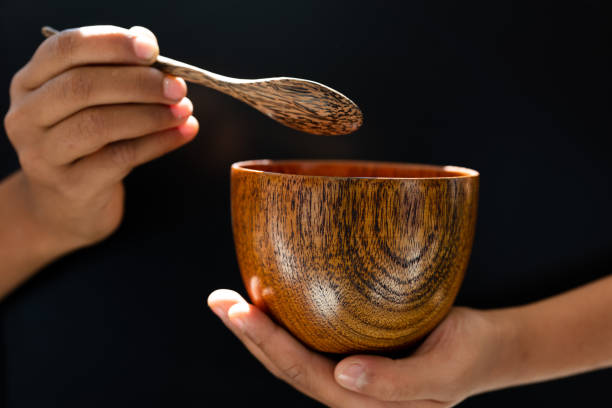 istock hand hold wood soup isolated on black background,front view 1192832755