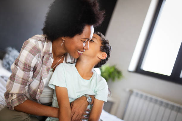 istock Happy mother playing, having fun, hugging with her son at home 1192832919