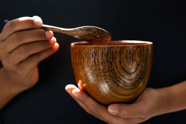 istock hand hold wood soup isolated on black background,front view 1192833042