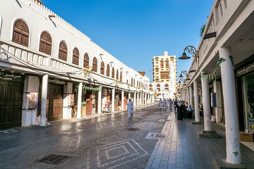 December 7th 2019, Jeddah, Saudi Arabia: The Nadaa Souq Street, sometimes also called Qabel Trail or Gabel Street, leads people into the Souk al Alawi Street, which forms the touristic center of Al Balad. Muslim pilgrims on their touristic pilgrimage exploring the grungy street.