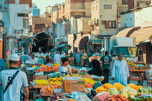 December 7th 2019, Jeddah, Saudi Arabia: The Souq Al-Hababa at the Souk Baab Makkah Street is a busy vegetable and fruit street market in Balad, Jeddah. On this bustling street, vendors advertise their best fruits, potential customers are looking at the products. People strolling along the market. Apart from the grunge, that's an amazing place!