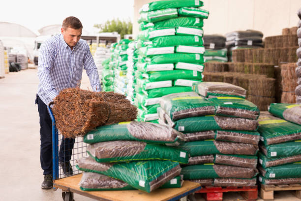 istock Man choosing compost soil in plastic bags in hypermarket 1192835424