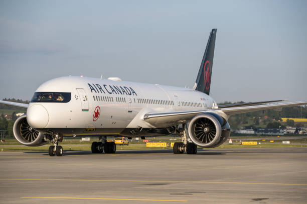 Air Canada Boeing 787-9 Dremliner Zürich, Switzerland - May 12 2019: Boeing 787 of Air Canada at Zurich airport. Air Canada is the flag carrier and the largest airline of Canada by fleet size and passengers carried. The airline, founded in 1937, provides scheduled and charter air transport for passengers and cargo to 207 destinations worldwide. It is a founding member of the Star Alliance. canada flag blue sky clouds stock pictures, royalty-free photos & images