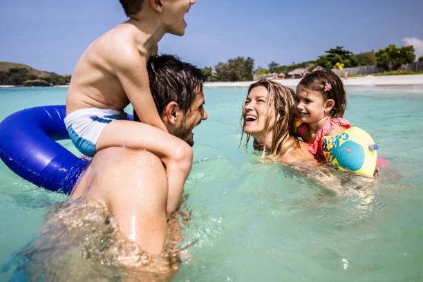 istock Cheerful family having fun while talking in summer day at sea. 1192836822