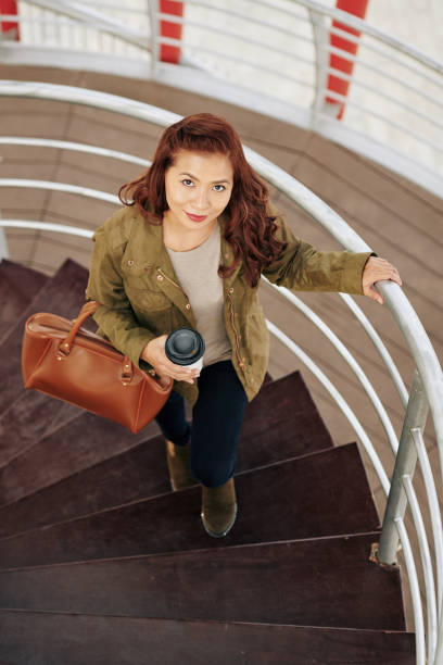 istock Woman walking with coffee cup 1192837555