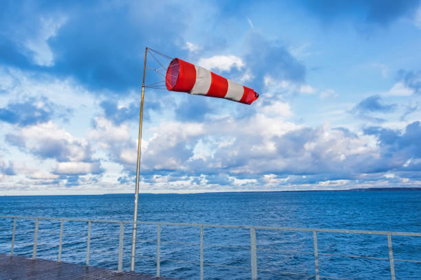 windmill cone on a pier in a seaport in windy weather. - anemometer meteorology measuring wind imagens e fotografias de stock