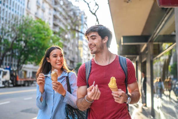 istock Young Travelers Walking and Talking with Ice Cream Cones 1192840514