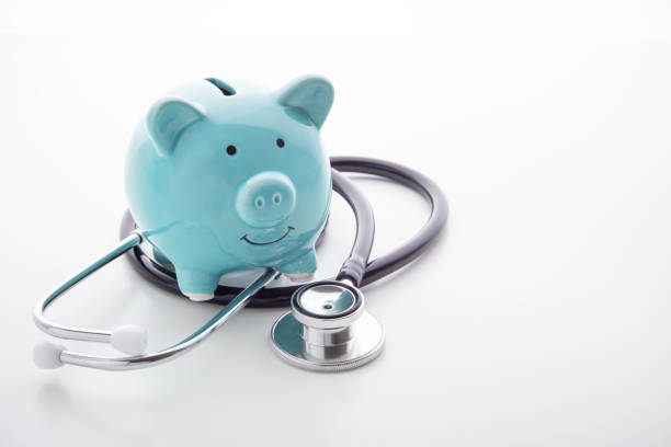 istock Piggy bank with stethoscope on white background 1192840713