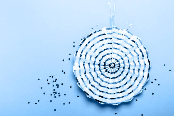 istock Paper striped decoration on blue background. Party concept 1192840789