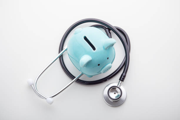 istock Piggy bank with stethoscope, top view 1192840858