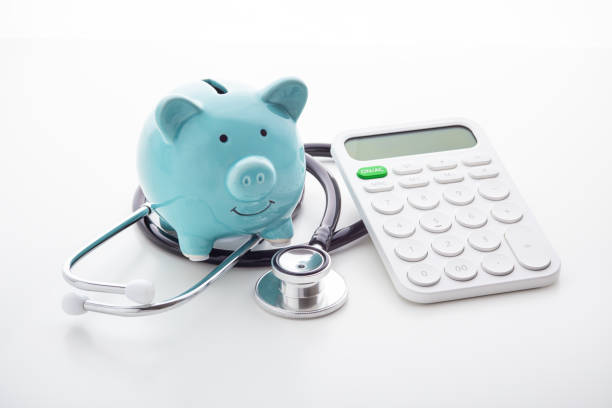 istock Piggy bank with stethoscope and calculator 1192841440
