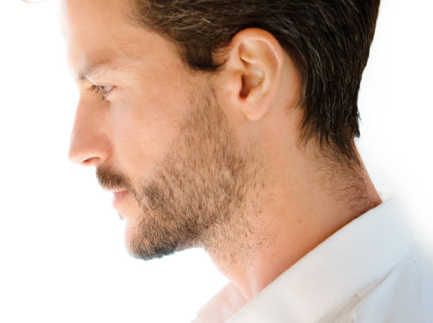 A confident young man in a white shirt