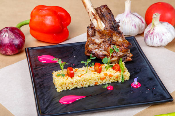 istock Baked pork knuckle with rice on a black plate. 1192843455