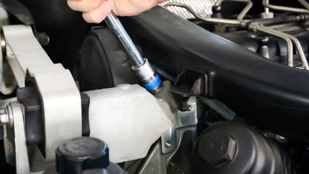 istock Mechanic uses socket wrench tighten nut of diesel engine 1192844254
