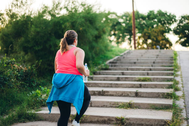 istock Young overweight woman running 1192844868