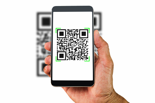 Hand holding smartphone scanning QR code on white background, business concept