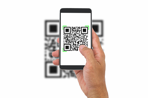 Hand holding smartphone scanning QR code on white background, business concept