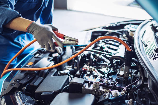 Mechanic man maintenance jump battery charging the engine a vehicle car hood, Safety inspection test engine before customer drive on a long journey, transportation repair garage service center Mechanic man maintenance jump battery charging the engine a vehicle car hood, Safety inspection test engine before customer drive on a long journey, transportation repair garage service center hopper car stock pictures, royalty-free photos & images