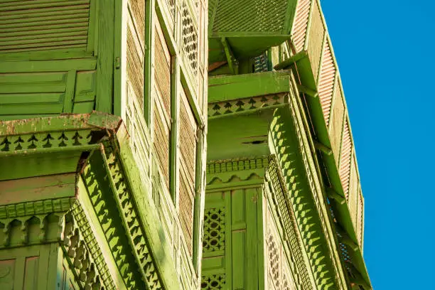 Photo of Close-up view of the greenish Noorwali (also called Noor Wali) coral town house at the Souk al Alawi Street in the historic city center of Al Balad, Jeddah, Saudi Arabia