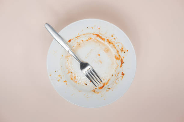 istock A plate with rests of tomato sauce in it, top view. 1192847835