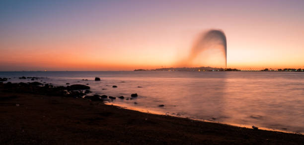 Panoramic view of the King Fahd's Fountain, the world's tallest fountain, seen from the South Corniche, Jeddah, Saudi Arabia, with a beautiful sunset in the background December 8th 2019, Jeddah Saudi Arabia. The world's tallest water fountain is seen from all over the south corniche, the promenade of Jeddah. saudi arabia jeddah landscape stock pictures, royalty-free photos & images