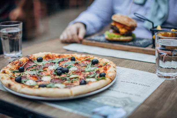 istock Pizza and burger on table in restaurant 1192848647