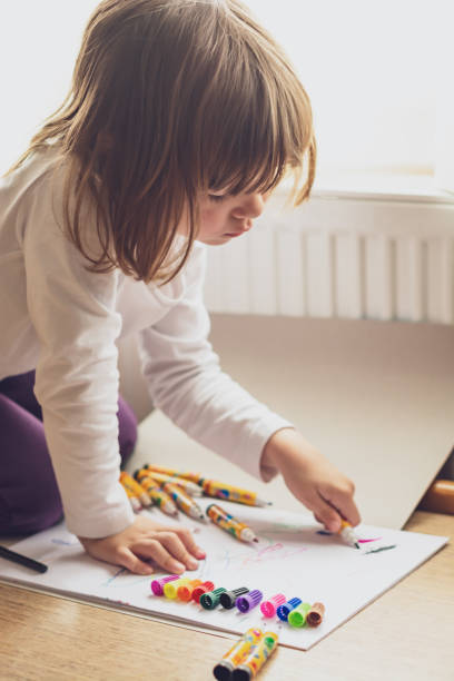 istock Cute little girl drawing at home. 1192848761