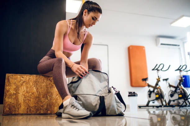 istock Woman opening gym bag 1192852170