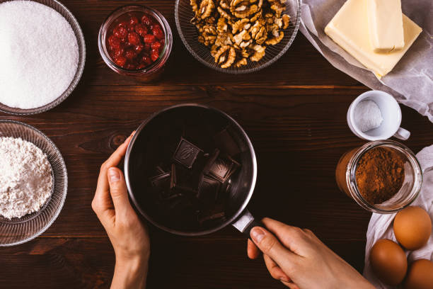 istock Woman's hands holding stewpan with chocolate 1192854001