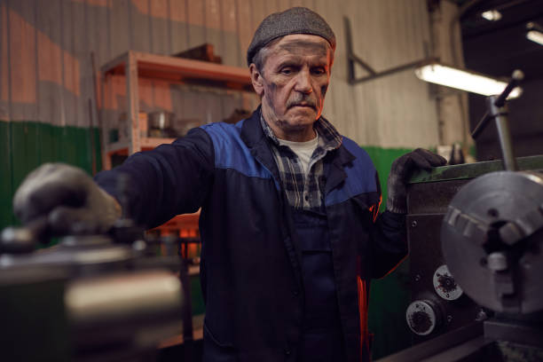 istock Senior man working at the lathe 1192854033