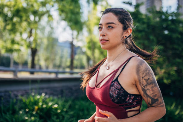 istock Beautiful young woman jogging in park. 1192854375