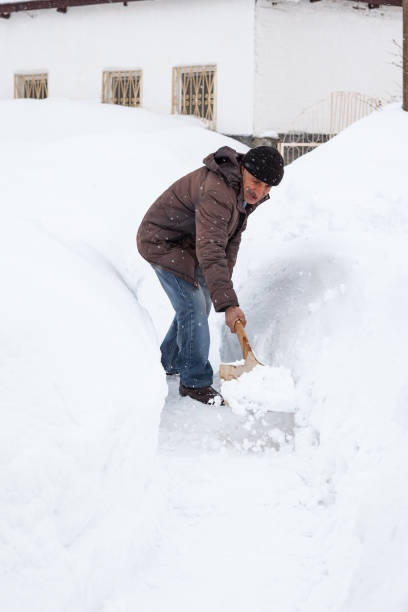istock Adult Man Cleaning Snow 1192858141