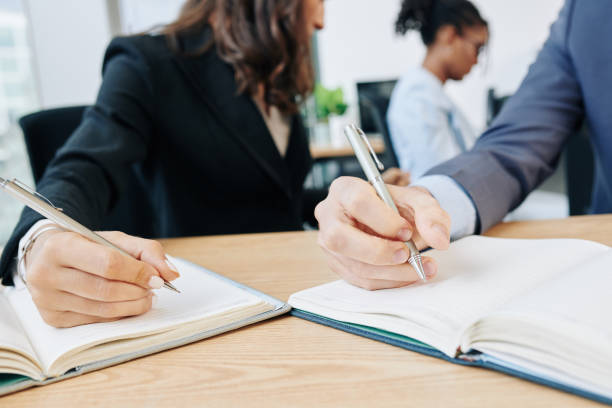 istock Business people writing in planners 1192858598