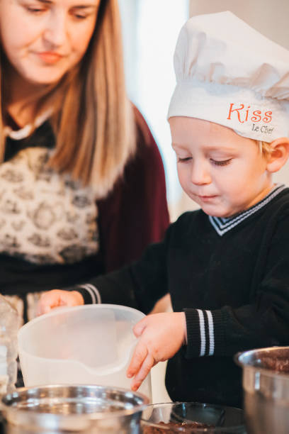 istock Mother with her son preparing dough for cookies 1192858831