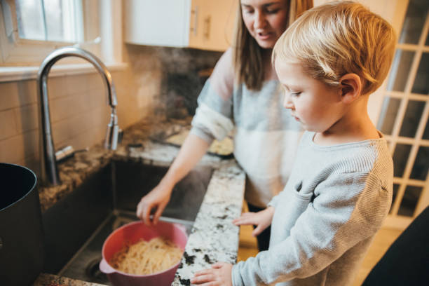 istock Mother and Son cooking pasta in the kitchen 1192860080