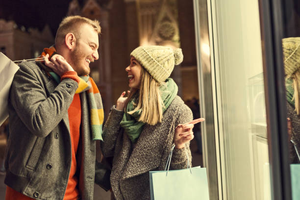 istock Young woman pointing in a store window during holidays 1192861188