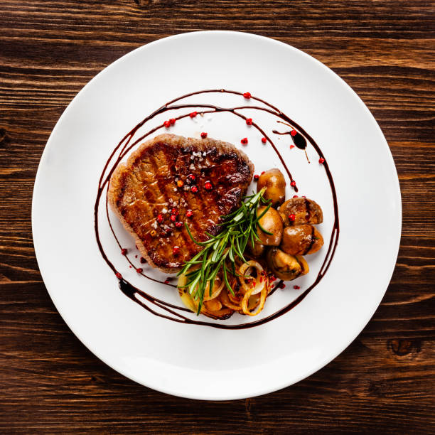 istock Beef steakwith mushroom on timber 1192861346