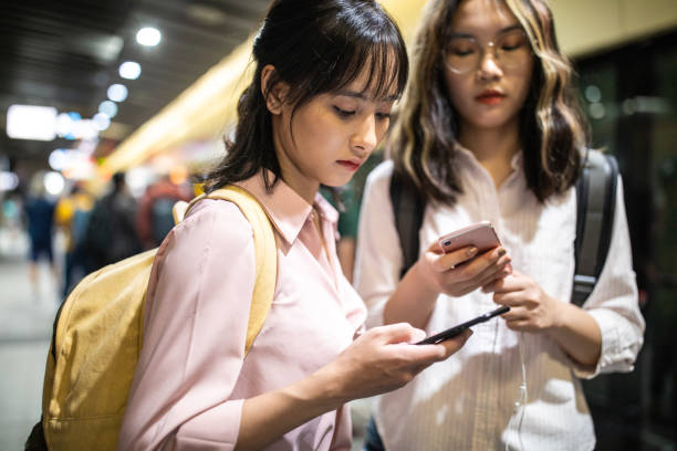 istock Teenage students using mobile phone at subway station 1192862226