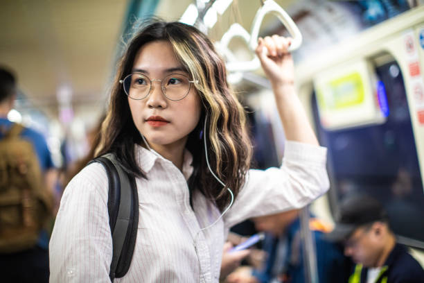 istock Cute university student using subway train on the way to school 1192862482