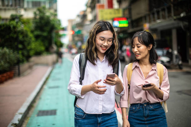 istock Urban students using smart phone on their way to the university 1192862496