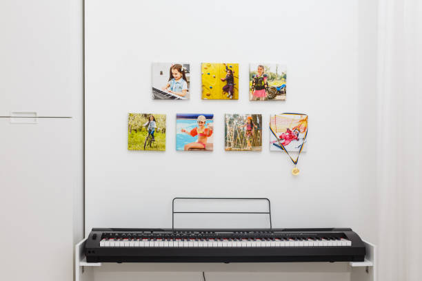 istock Some photos hanging on a rope, white wall background, next is an electronic piano 1192862574